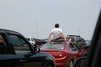 man on roof of car