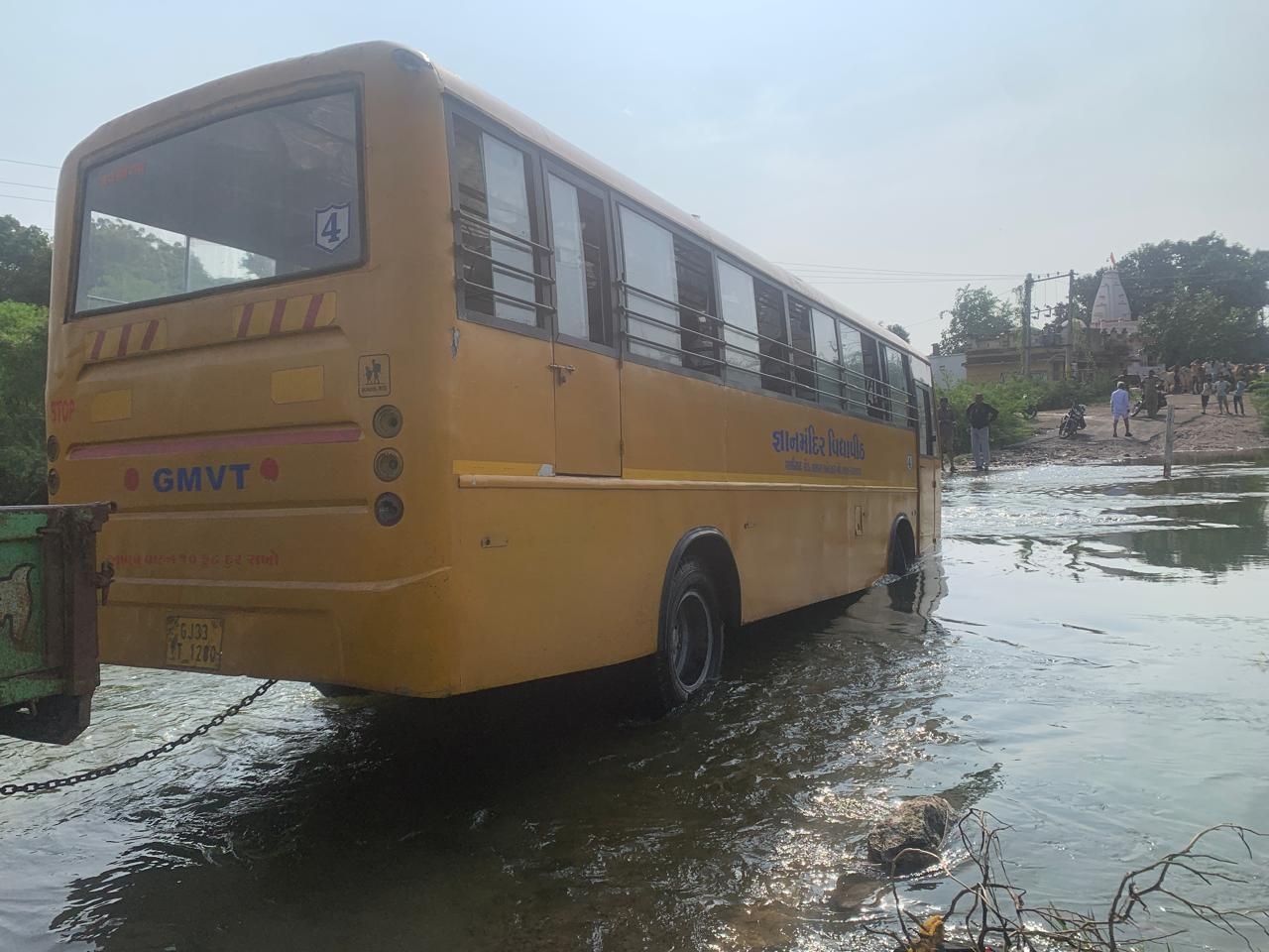 bus stuck rain river